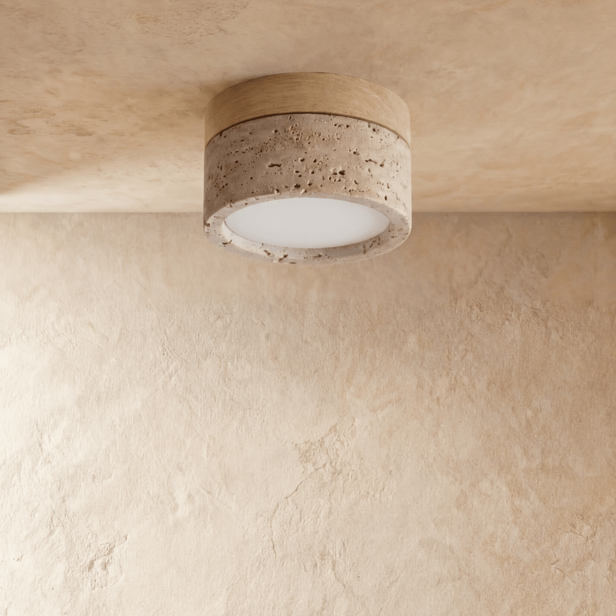 Clérachic ceiling light with a light wood band over a speckled travertine-look drum, glowing warm overhead.