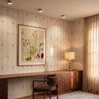 Clérachic ceiling lights in light wood glowing above a wallpapered home office with a wood desk and lamp.