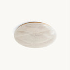 A round Clérachic ceiling light with a ribbed, frosted-glass look shade and a thin gold rim, unlit on a plain off-white backdrop.