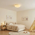 This Clérachic ceiling light glows in a child's bedroom with a play tent, framed animal prints and a round rug.