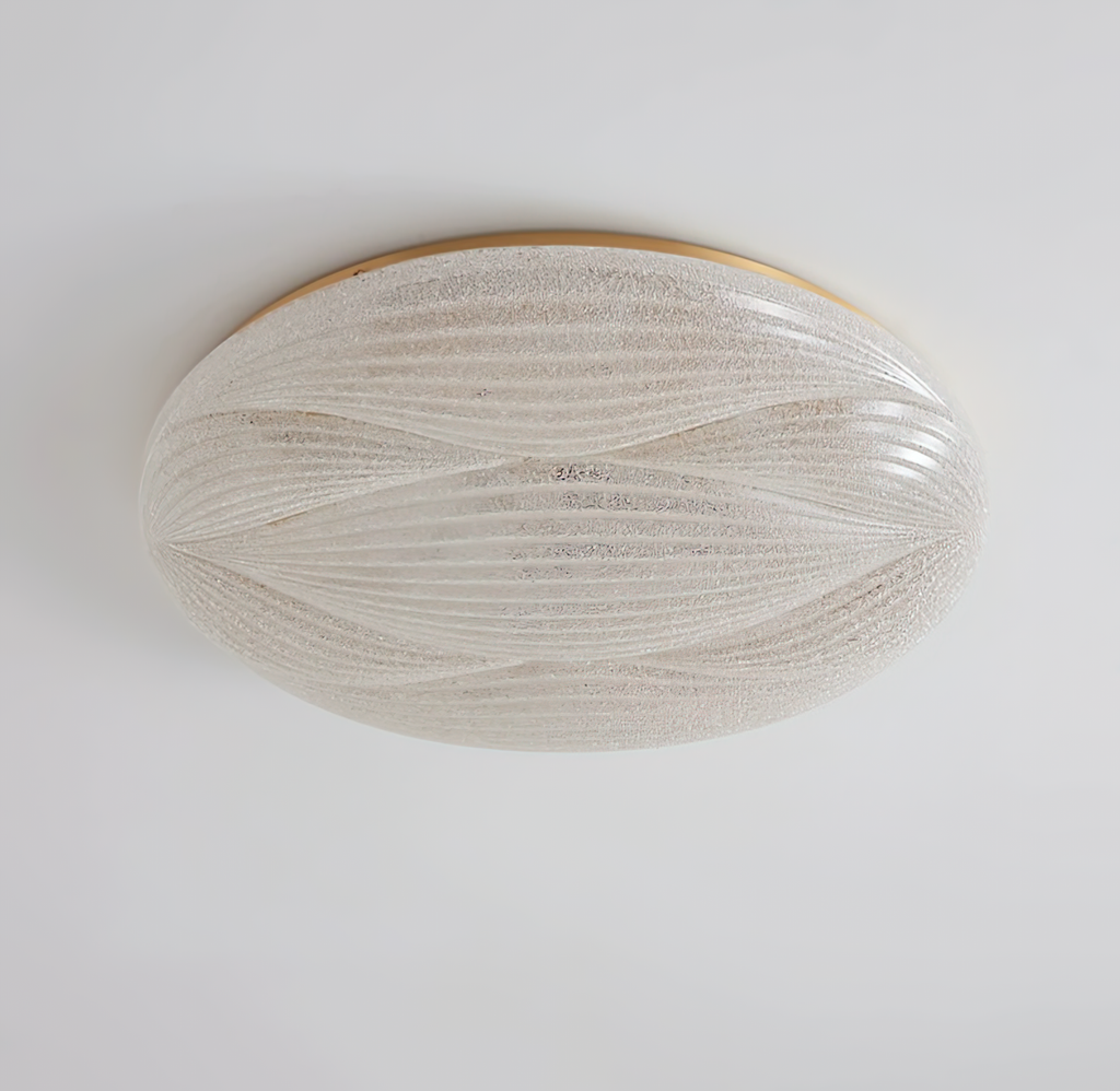 Side view of this unlit Clérachic ceiling light, its gold rim and sparkly textured shade set against a pale ceiling.