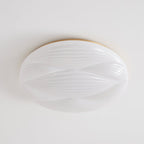 Smooth white ribbed shade and a thin gold rim on this unlit Clérachic ceiling light, seen from below.