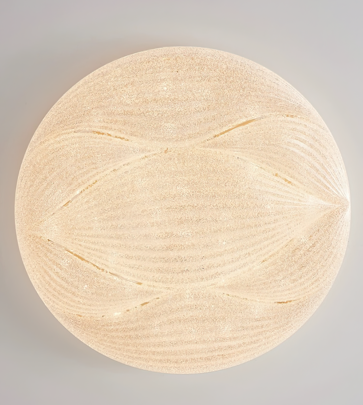 Straight-on view of the lit, crystal-textured shade of this Clérachic ceiling light, with wave lines crossing the glass.