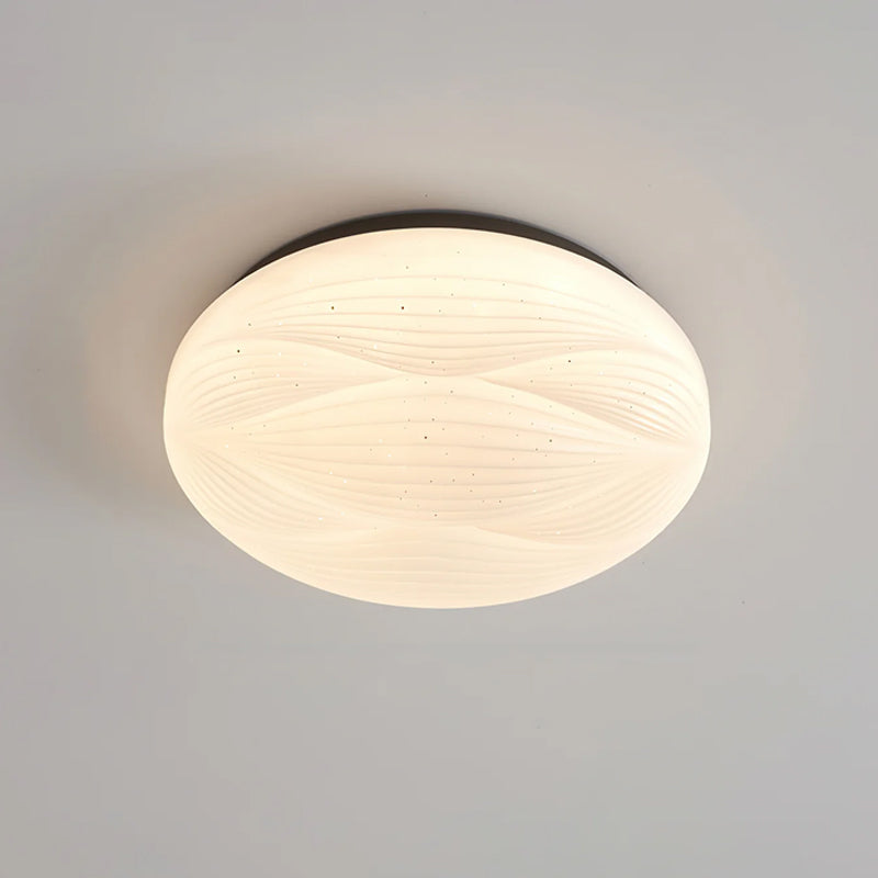 The black rim frames the glowing ribbed shade of this Clérachic ceiling light, seen from below on grey.
