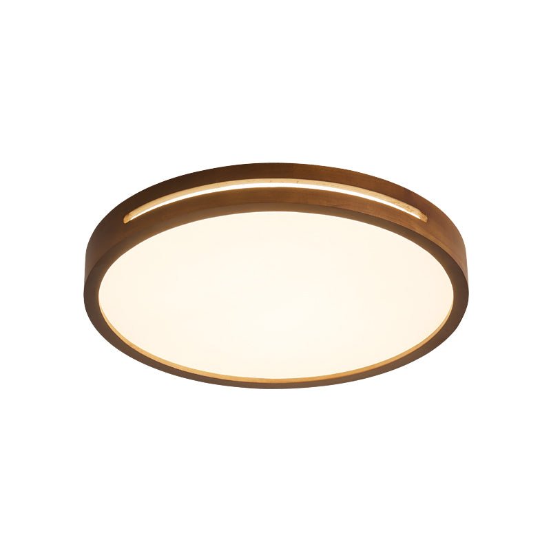 Round walnut-wood Clérachic ceiling light on a white backdrop, seen from the side with its frosted panel and slim slot.