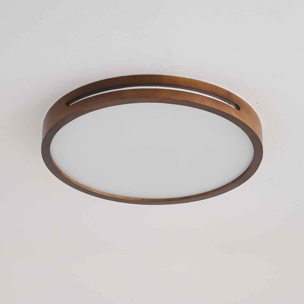 Round walnut-frame Clérachic ceiling light switched off, showing the matt white frosted panel inside the wood ring.