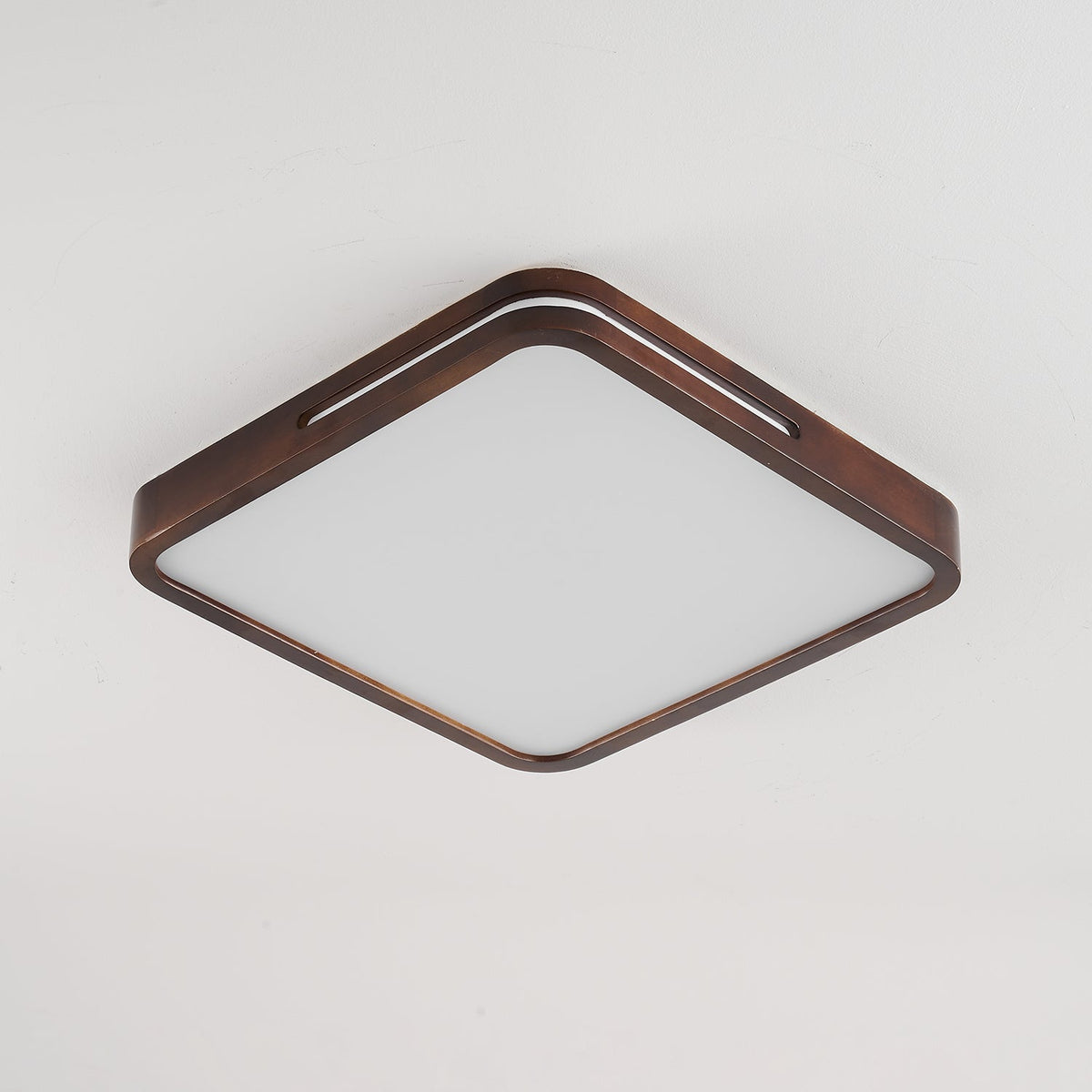 Square walnut ceiling light from Clérachic with rounded corners, switched off so the frosted panel looks plain white.