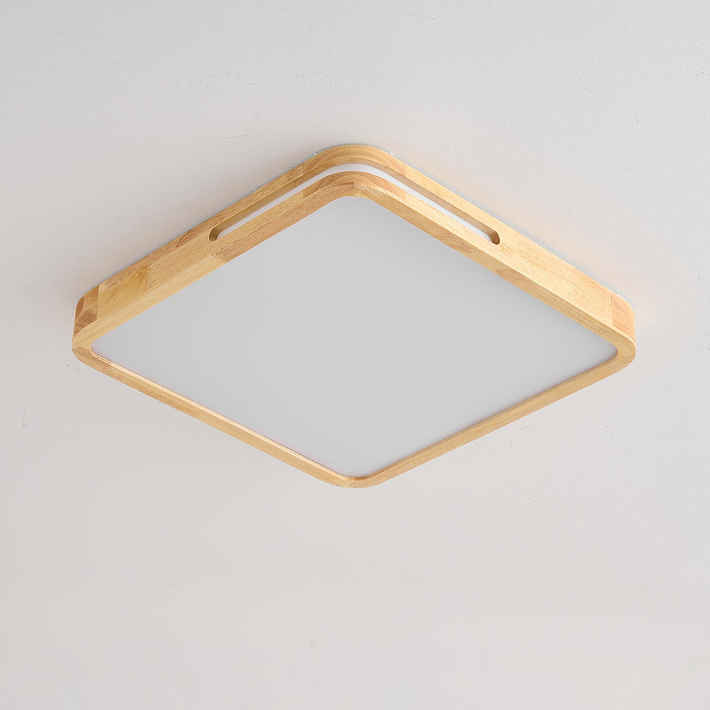 Square pale wood ceiling light from Clérachic, unlit, with a slot cut into two sides of the frame and a white panel.