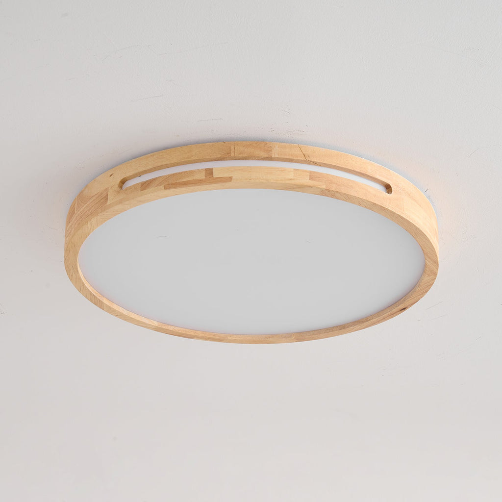 Large round ceiling light from Clérachic in a pale wood finish, unlit, with visible joined timber blocks around the rim.
