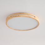 Large round ceiling light from Clérachic in a pale wood finish, unlit, with visible joined timber blocks around the rim.