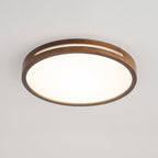 Round dark wood Clérachic ceiling light, lit, with a slim slot in the frame and an even white glow across the panel.