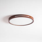 Round walnut ceiling light from Clérachic, switched off, photographed at a low angle to show the slim 5.5 cm depth.