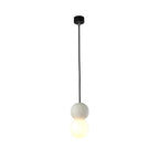 This Clérachic pendant, a pale stone-textured sphere above an opal glass globe, hangs on a black cord against a white background.