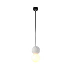 This Clérachic pendant, a pale stone-textured sphere above a lit opal glass globe, drops from a black ceiling canopy on white.