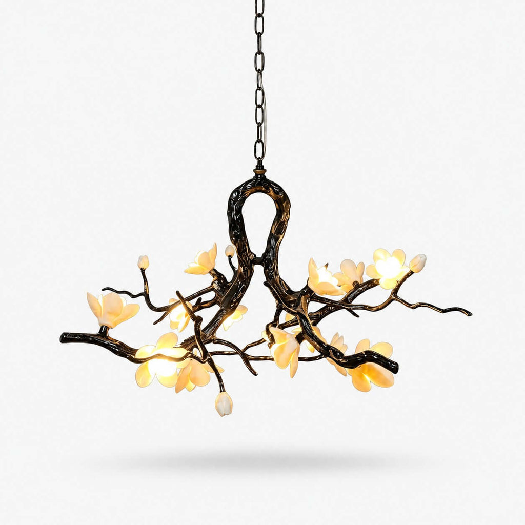 This Clérachic chandelier on a plain white backdrop, a dark twisted branch frame with an open loop, hung on a chain and lit by glowing cream flowers.