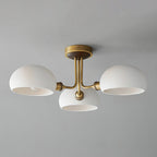 Unlit brass and white ceramic ceiling light from Clérachic against a pale grey ceiling, the shades open downward.