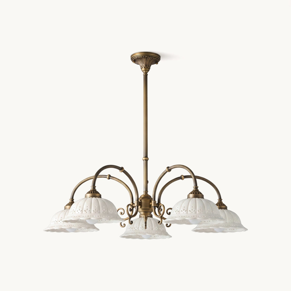 Five-light Clérachic chandelier with white pierced ceramic shades on curved antique brass arms, shown on a plain white background.