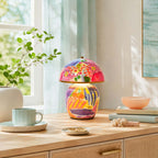 Shown here, a Clérachic table lamp on a light wood sideboard with a pale-blue mug, a peach bowl, shells and a sprig of green in a vase.
