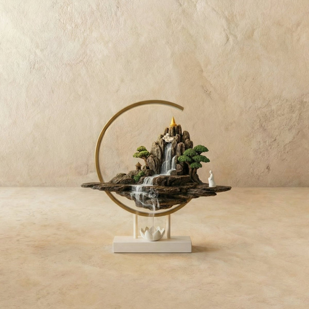 Clérachic incense burner lamp in the Hills finish, incense smoke drifting past bonsai trees inside its brass-toned LED ring.
