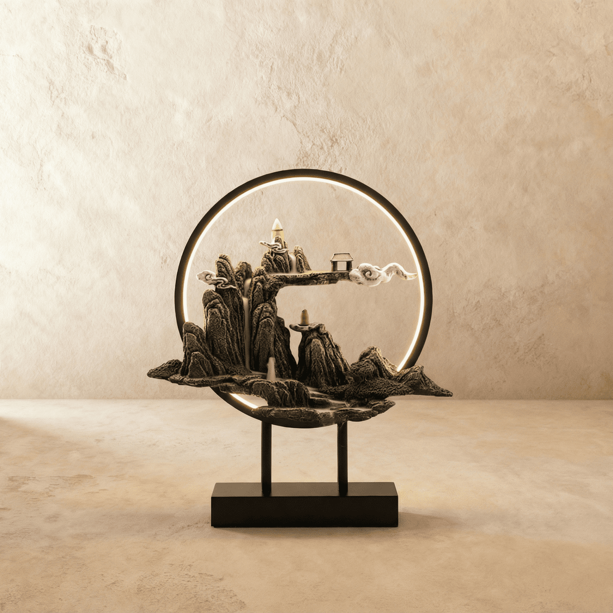 Clérachic Cloudy Hills incense burner lamp, a grey stone peak with a tiny pavilion and drifting cloud set inside a black ring.