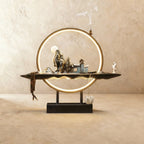 Clérachic incense burner lamp in the Home finish, mirror-polished peaks and tiny houses under a moon inside a lit ring.