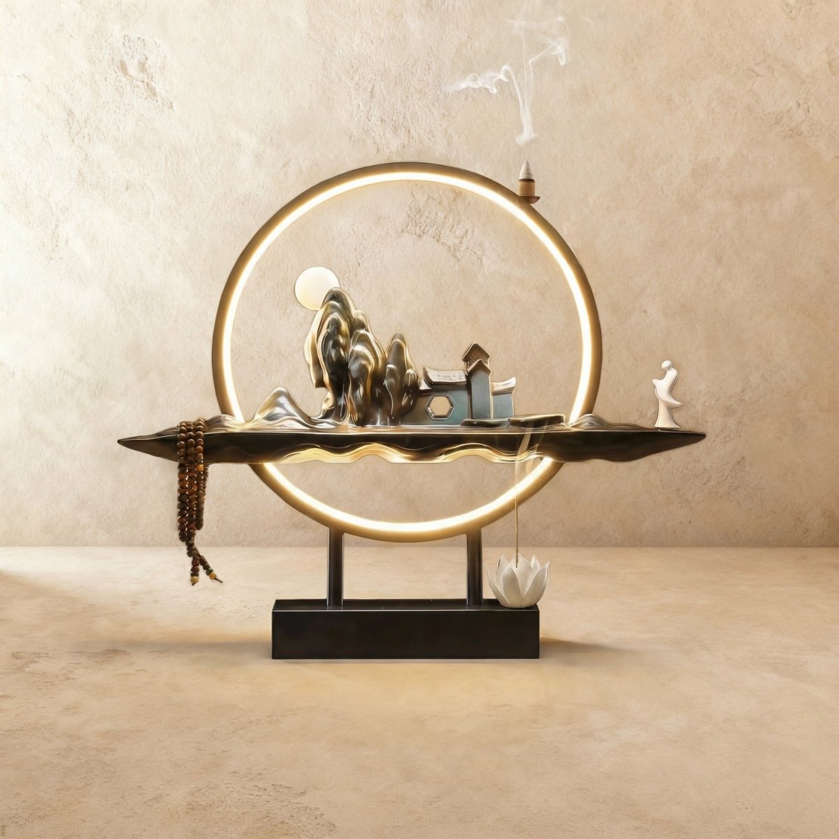Clérachic incense burner lamp in the Home finish, mirror-polished peaks and tiny houses under a moon inside a lit ring.