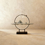 Clérachic Gray Mountain incense burner lamp, a pale ridged peak sculpture with a small figure on a slim tray and lit ring.