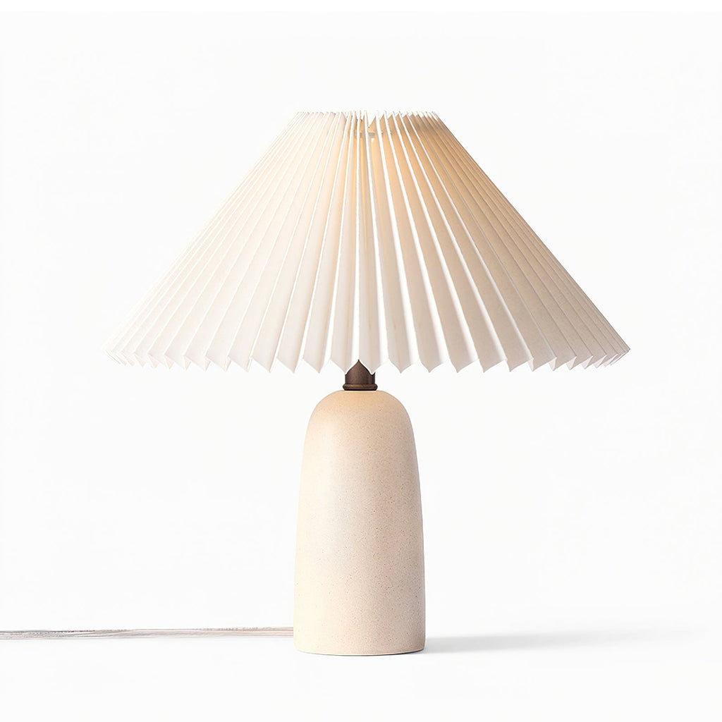 A beige Clérachic table lamp with a white pleated shade and a clear cord, unlit on a plain white backdrop.