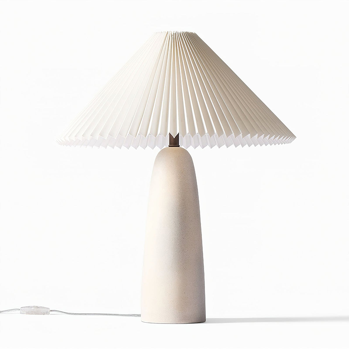 A taller Clérachic table lamp with a beige ceramic base and wide pleated shade, unlit on white, with an in-line switch on the cord.