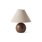 Front view of the Clérachic table lamp on white, a conical natural linen shade above a round walnut wood-grain base.