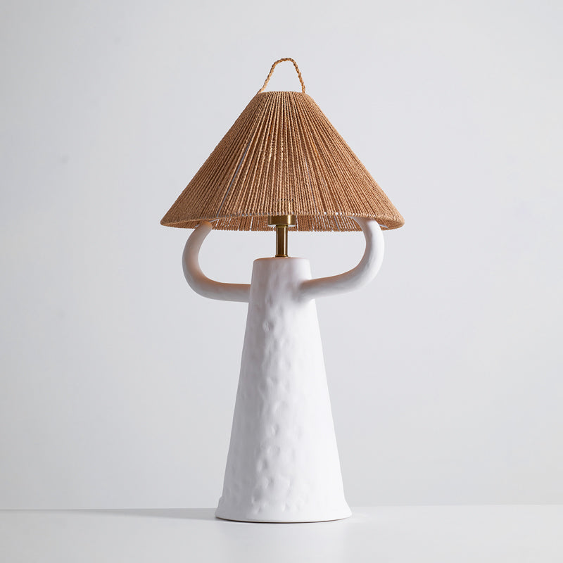 White version of this Clérachic table lamp, its dimpled ceramic body and arms below a rope-wound cone shade, on a pale grey background.
