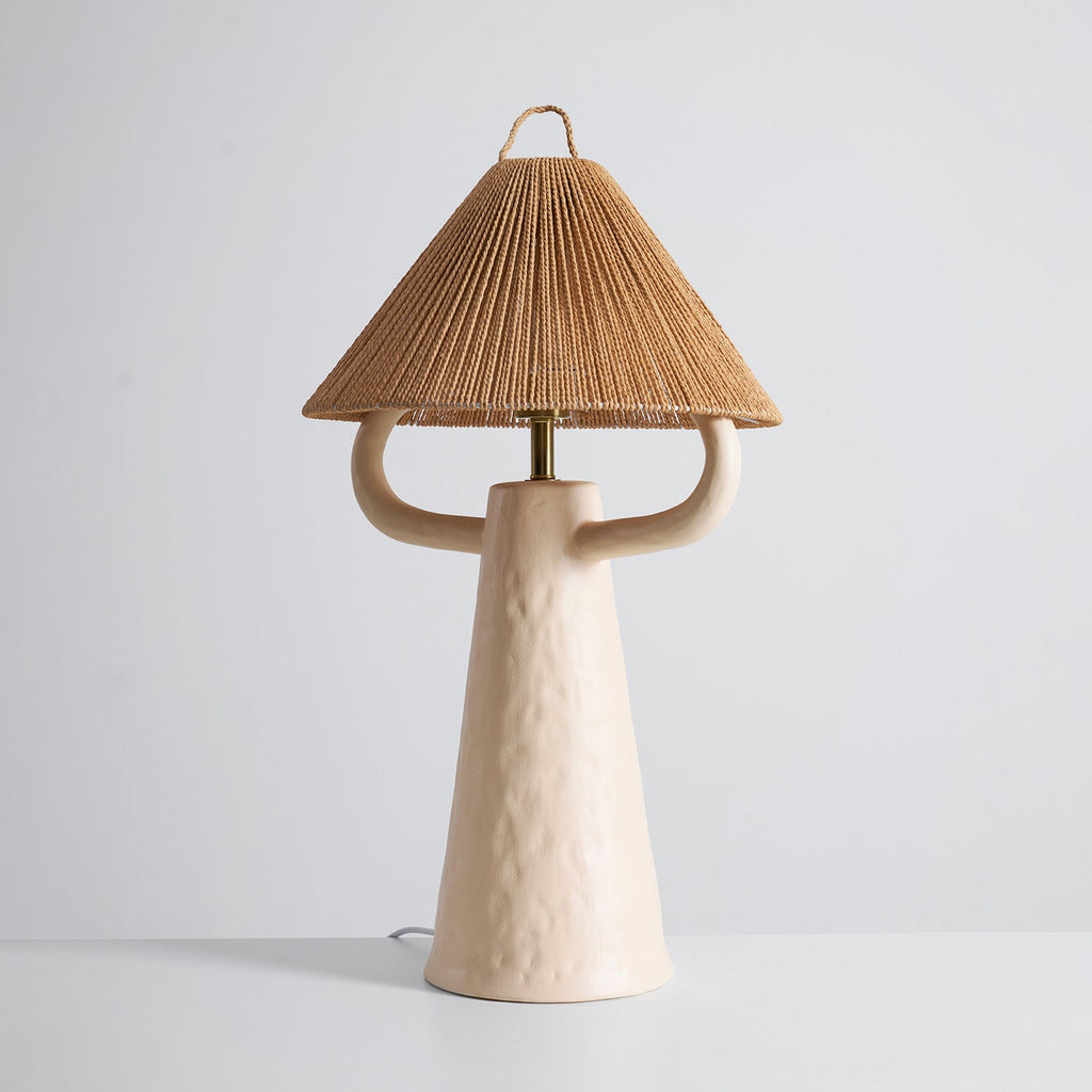 Cream Clérachic table lamp seen from slightly higher, its two arms reaching beneath a rope shade, on a pale grey backdrop.
