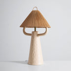 Cream Clérachic table lamp seen from slightly higher, its two arms reaching beneath a rope shade, on a pale grey backdrop.