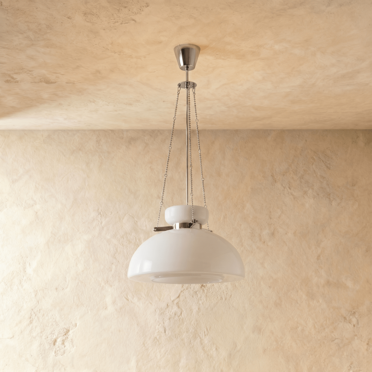 Clérachic white glass dome pendant on slim chains and a chrome canopy, switched off in front of a plaster wall.