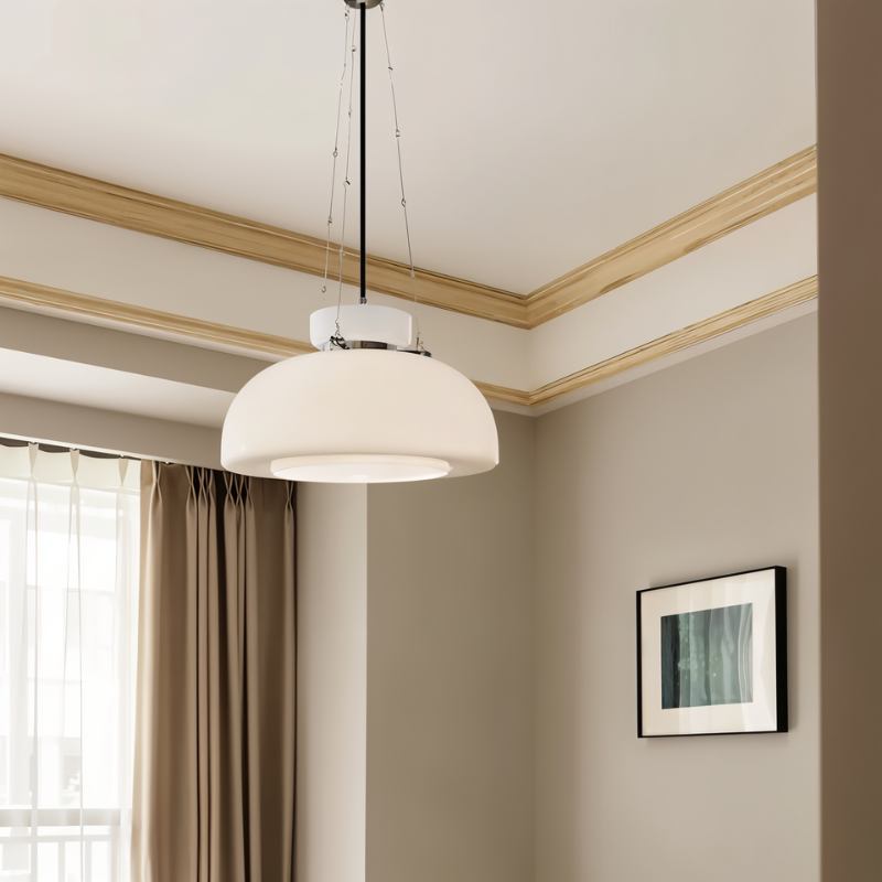 Clérachic white glass dome pendant hanging in a neutral room with a window, a wood cornice and a framed print.
