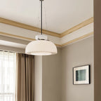 Clérachic white glass dome pendant hanging in a neutral room with a window, a wood cornice and a framed print.