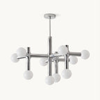 Chrome chandelier from Clérachic on a plain white backdrop, with frosted white spheres on crossing tubular arms below a slim ceiling rod.