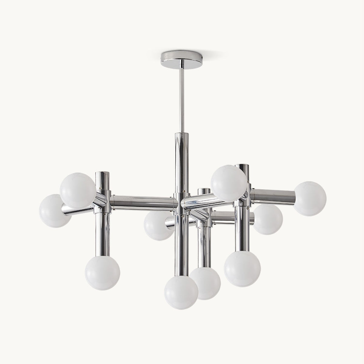 Chrome chandelier from Clérachic on a plain white backdrop, with frosted white spheres on crossing tubular arms below a slim ceiling rod.