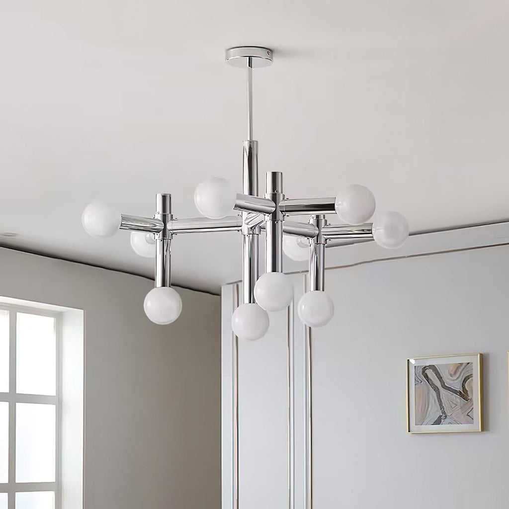 Close angle on the Clérachic chrome chandelier, its frosted globes clustered on tubular arms against a soft grey ceiling.
