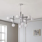 Close angle on the Clérachic chrome chandelier, its frosted globes clustered on tubular arms against a soft grey ceiling.