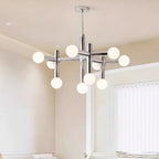 Chrome and frosted-glass chandelier from Clérachic in a warm-toned room with a tall window and sheer vertical blinds.