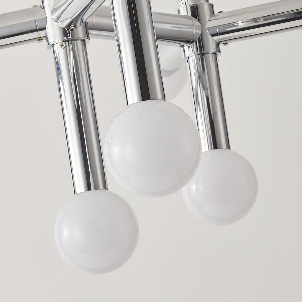 Close view of three frosted glass spheres on polished chrome tube arms, from the underside of this Clérachic chandelier.