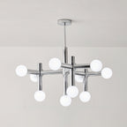 The same Clérachic chandelier switched off, with its ten frosted white globes and chrome crossing arms on a pale grey wall.