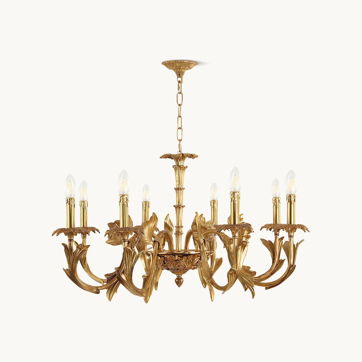 Antique brass candle-style chandelier from Clérachic on a plain white backdrop, with curved leaf-shaped arms and a hanging chain.