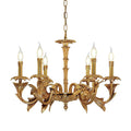 Smaller Clérachic brass chandelier on white, with flame-tip bulbs on curved leaf-shaped arms.