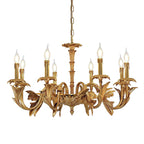 Clérachic brass chandelier on a white background, hanging from a fine chain with lit flame-tip bulbs above its leafy arms.