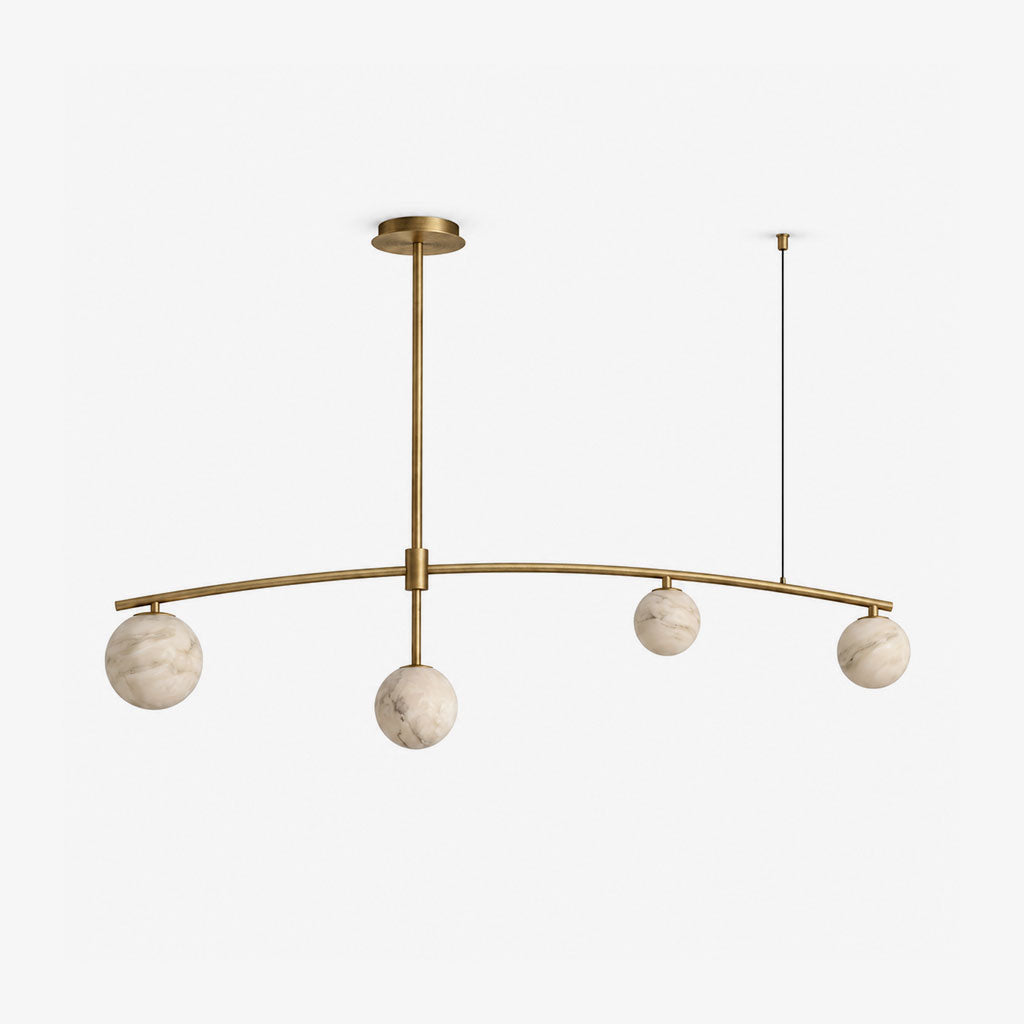 This Clérachic chandelier in brushed brass is shown alone, its arched bar suspending four alabaster ball shades.