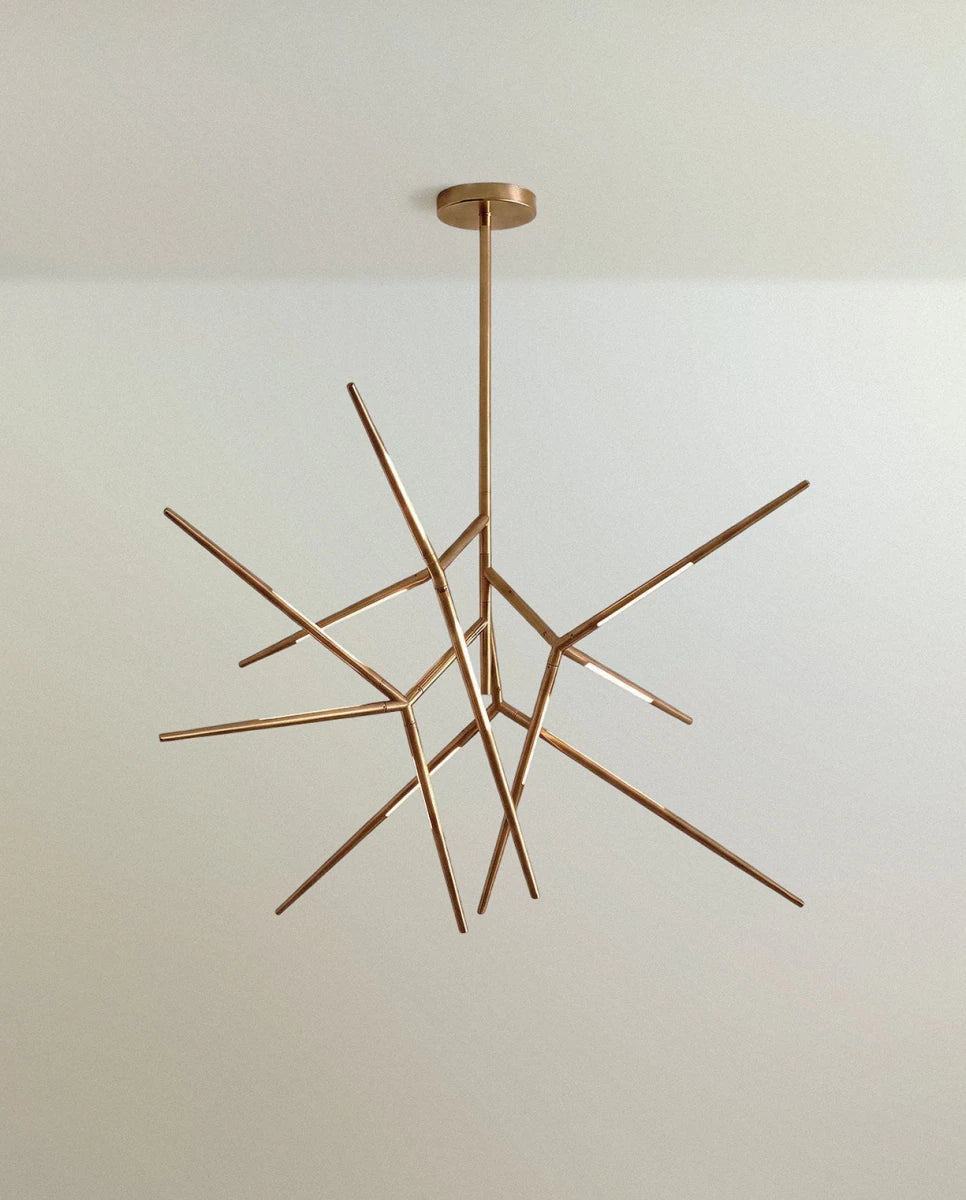 Clérachic branching rod chandelier in brushed gold, angular arms radiating from a slim stem and round ceiling canopy.