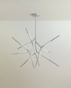 Clérachic branching rod chandelier in polished chrome, angular arms spreading from a slim stem and canopy.