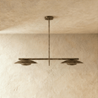 Clérachic chandelier in vintage brass, front view of the paired disc shades on their ceiling rod.